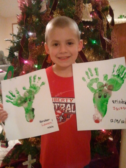 Jackson holds his and Lauren's reindeer, made out of foot and hand prints.