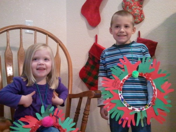 Lauren and Jackson display their unique wreaths, made of their hand prints.