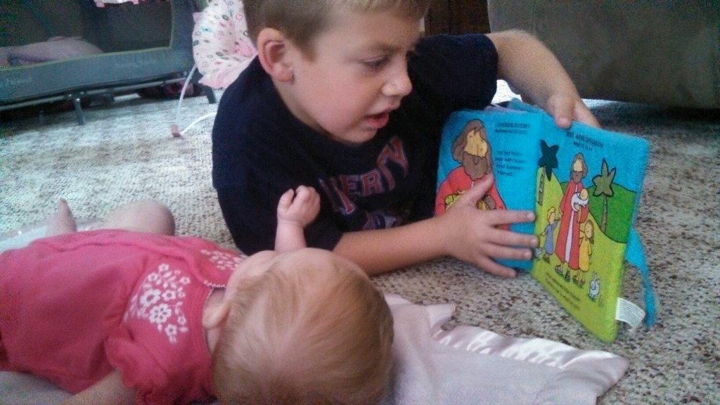 Jackson reads his baby Bible to Maci
