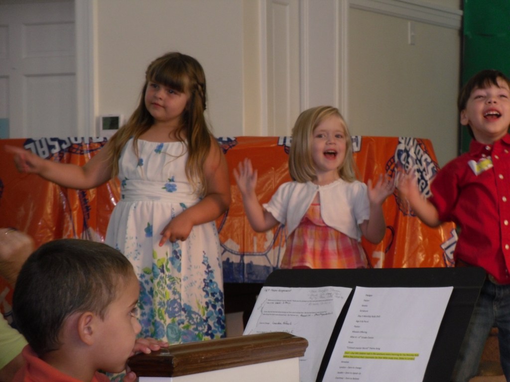 Lauren (in the middle) sings through her smiles.