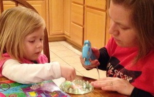 Lauren glues jewels on her CD ornament