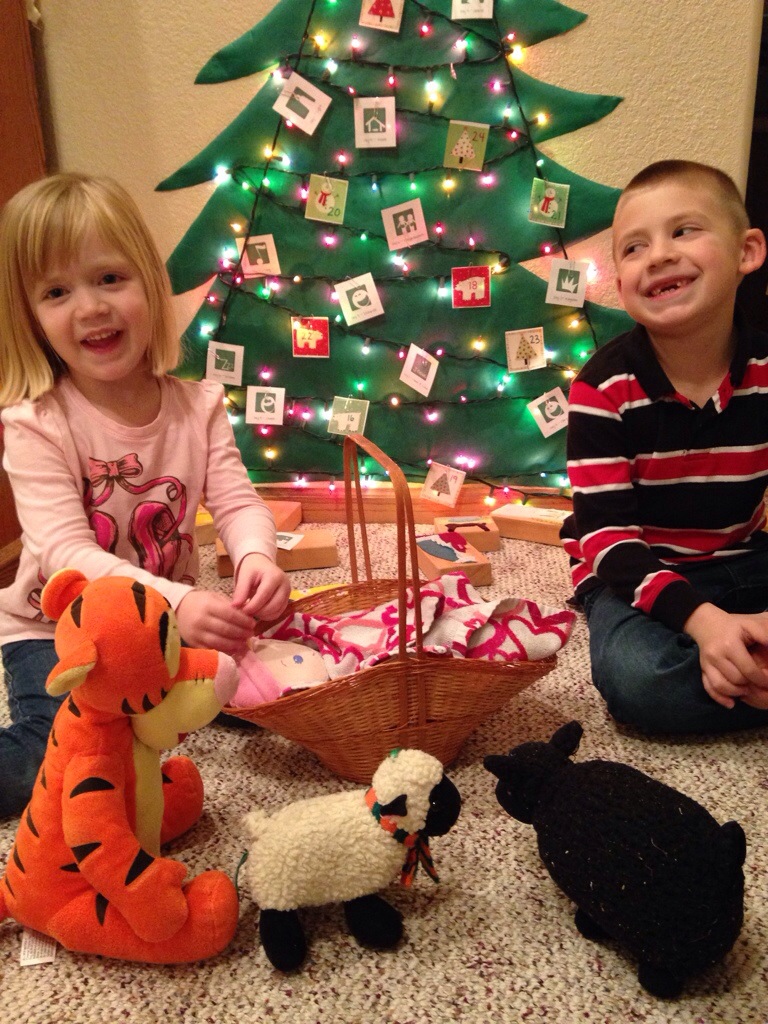 We made a manger tonight, and wrapped our baby tight, with stuffed animals looking on.