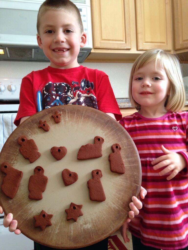 Jackson and Lauren hold their cinnamon ornaments just before baking.