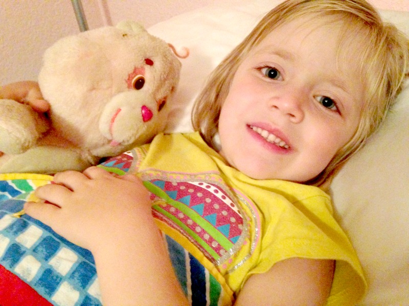 Lauren felt safe from the fireworks snuggled in her own bed with Cheer Bear.