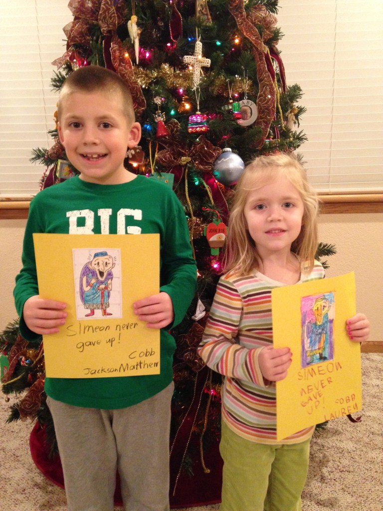 Jackson and Lauren show their art project puzzles of Simeon.