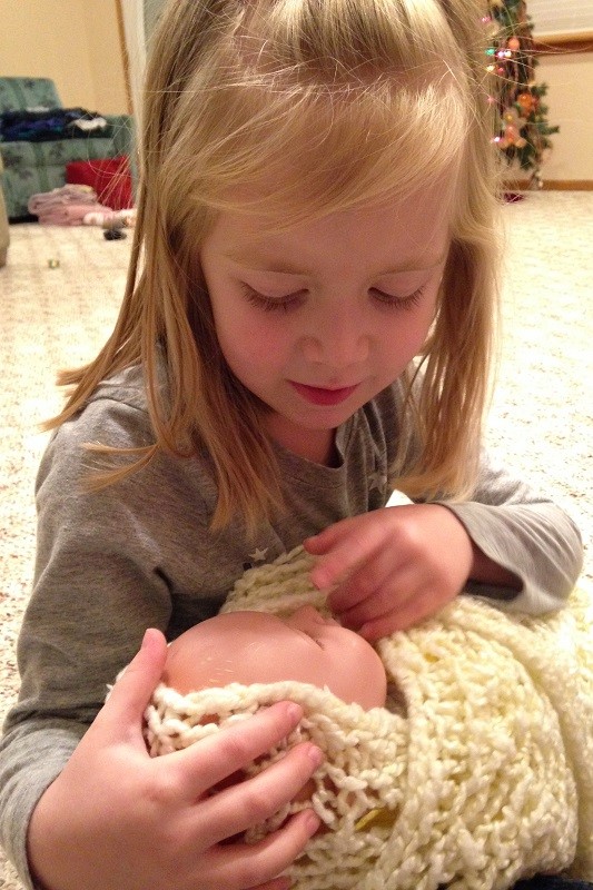 Lauren cradles our baby Jesus in her arms, imagining what it might have been like for the shepherds to see the Messiah.