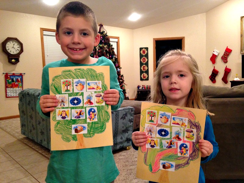 Jackson and Lauren hold up the family trees we made for Jesus.