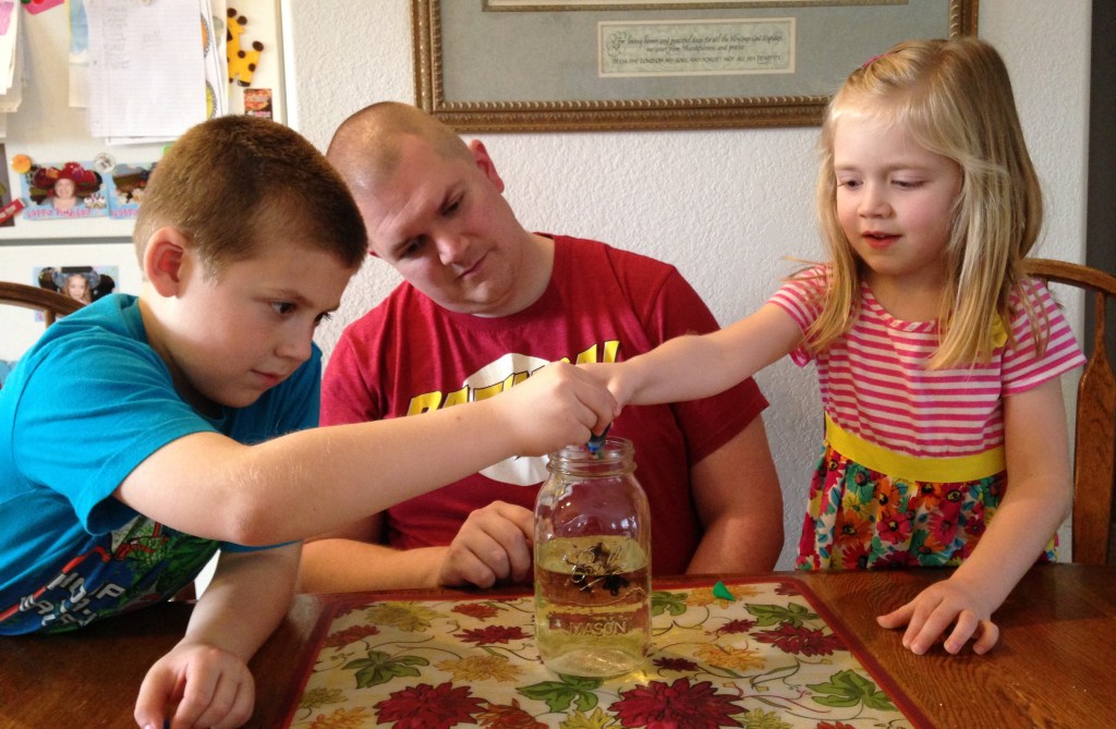 Jackson and Lauren put drops of food coloring (sin) into the jar as part of our sin science experiment to show how Jesus cleans our lives.